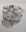 Charcoal drawing by Laila Pierce showing hands pressing into a fragmented torso on torn paper mounted to a wall.