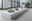 Installation view of bronze sculptures displayed on ceramic supports arranged along a white plinth in a studio gallery space.