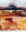 Abstract landscape in warm earth tones with misty horizons, layered fields and delicate linear marks suggesting grasses.