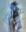 Layered digital photograph of a partially obscured human figure rendered in translucent blue tones, with overlapping forms creating a ghostly, dreamlike presence.