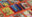 Collection of colourful Swerve magazine covers arranged on an orange surface, featuring editorial layouts, illustrations, photography, and typography.
