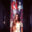 Artist Haley Craw standing in front of a tall figurative painting installation.
