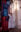 Performance artist reaching upward beside a monumental figurative painting in a historic church gallery.