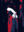 Stylized portrait of a blindfolded figure in profile, rendered in bold red, black, white, and navy tones against a dark background.