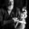 Portrait of Canadian puppeteer and sculptor Ken Flett holding a hand-carved marionette while seated in his studio.