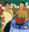 Acrylic painting of two elegantly dressed women seated at a table with flowers, wine glasses and decorative blossoms, rendered in bold green, red, blue and cream tones.