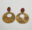 Pair of circular brass earrings by Karen Kryzan with warm mottled surfaces and reddish copper studs, created using reticulation and heat-painting techniques.